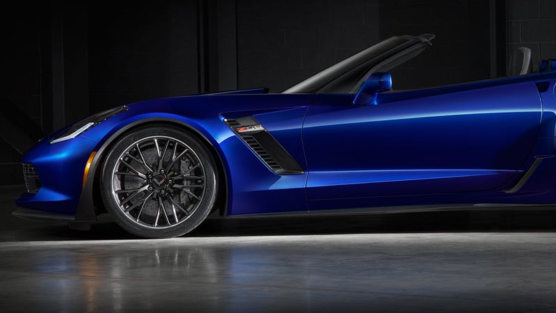Side profile of a blue sports car on a screen.