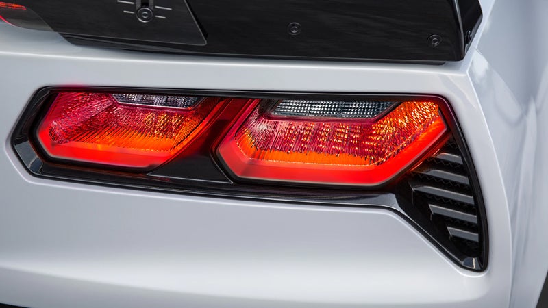 Rear taillights of a white sports car.