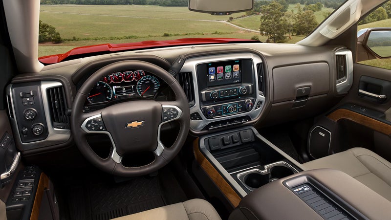 Interior view of a Chevrolet Silverado showing the steering wheel, dashboard, and center console with a touchscreen display.