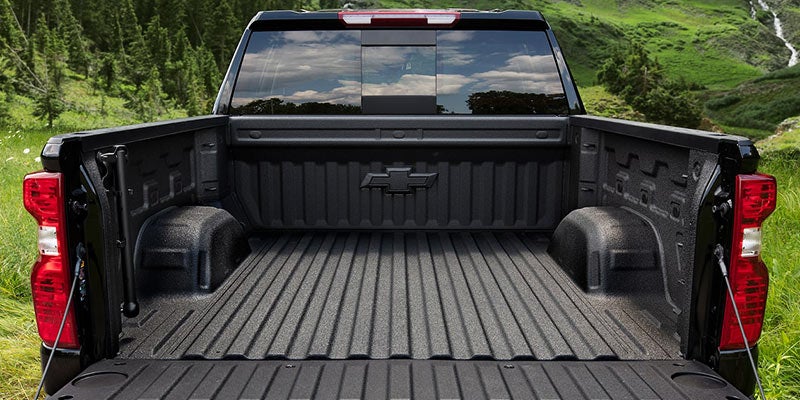 Close-up of a Chevrolet Silverado's rear bumper corner with an integrated step for easier truck bed access.