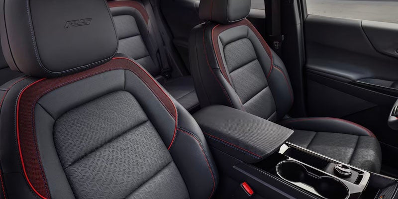 Black leather Chevrolet seats with red stitching and "RS" logo.